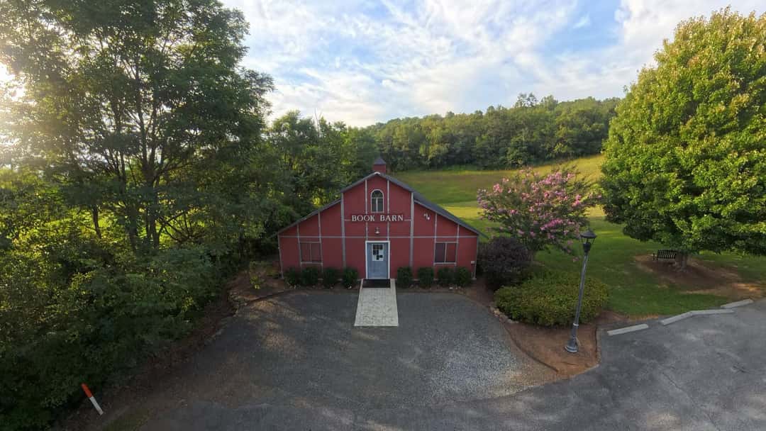 The Book Barn at the top of its gravel drive, with the hill behind it.